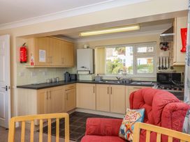 A kitchen with cabinets and appliances at Beachside