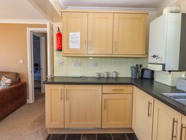 A kitchen with cupboards and appliances at Beachside