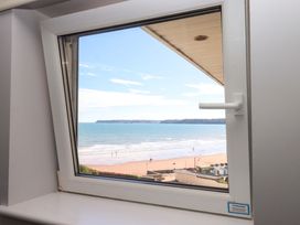 A window view of the beach with ocean and sand at Beachside