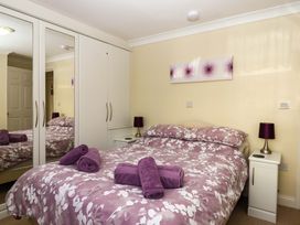 A bedroom with a bed and wardrobe at Beachside