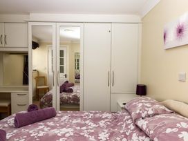 A bedroom with a bed and wardrobe at Beachside