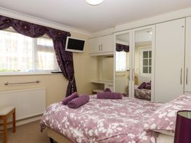 A bedroom with a bed and wardrobe at Beachside