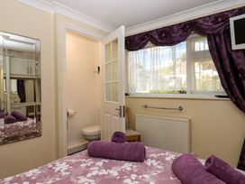 A bedroom with a bed and adjoining bathroom at Beachside in 