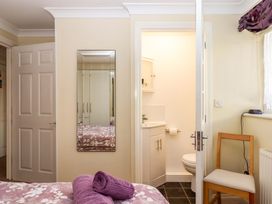 A bedroom with a mirror and bathroom door at Beachside