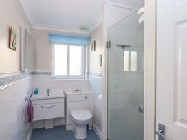 A bathroom with a sink, toilet, and shower at Beachside