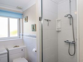 A bathroom featuring a shower and toilet at Beachside