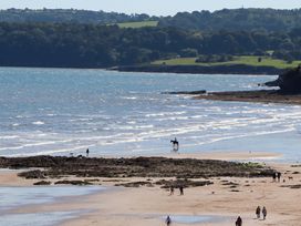 A beach with people and a horse at Beachside