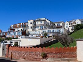 A collection of apartments with balconies and a brick wall at Beachside