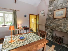 A dining room with a table and chairs at Tyn Y Fron in Brynherbert near Llanrhystud