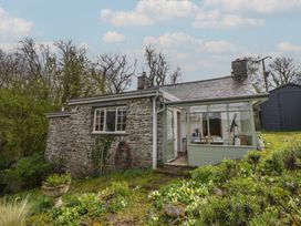 A cottage with a conservatory and garden at Tyn Y Fron in Brynherbert near Llanrhystud