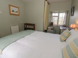 A bedroom with a bed and a desk at Tyn Y Fron in Brynherbert near Llanrhystud