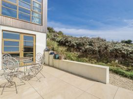 An outdoor area with a table and chairs at Teach Tra East Perranporth