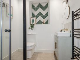 A bathroom with a sink and toilet at Teach Tra East in Perranporth