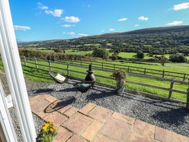 An outdoor seating area with a view at Sychnant Farm Retreat Llanedi near Pontarddulais