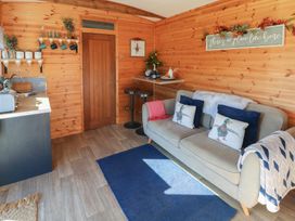 A living room with a sofa and bar table at Sychnant Farm Retreat in Llanedi near Pontarddulais