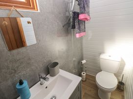 A bathroom with a sink, toilet, and shower at Sychnant Farm Retreat in Llanedi near Pontarddulais