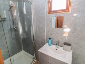 A bathroom with a shower and sink at Sychnant Farm Retreat in Llanedi near Pontarddulais