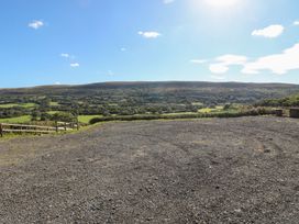 An outdoor area with gravel surface and hills in the background at Sychnant Farm Retreat Llanedi near Pontarddulais