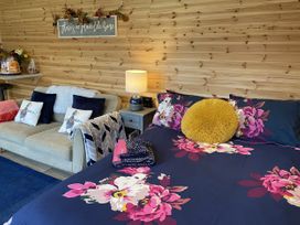 A living room with a bed and a sofa at Sychnant Farm Retreat Llanedi near Pontarddulais