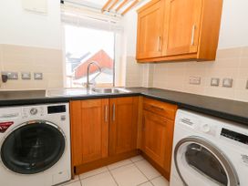 A laundry room with a washing machine and dryer at Harbour Heights in Weymouth