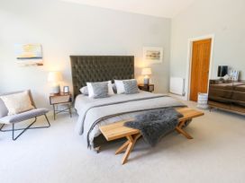 A bedroom with a bed, bedside tables, and a wardrobe at Harbour Heights in Weymouth