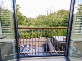 A balcony with a view overlooking greenery and outdoor seating at Harbour Heights in Weymouth