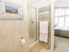 A bathroom with a shower and towel warmer at Harbour Heights in Weymouth