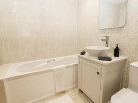A bathroom with a bathtub, sink, and toilet at Harbour Heights in Weymouth