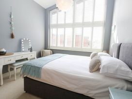 A bedroom with a bed and dressing table at Harbour Heights in Weymouth