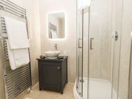 A bathroom with a shower and vanity unit at Harbour Heights in Weymouth