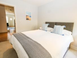 A bedroom with a bed and wall art at Harbour Heights in Weymouth
