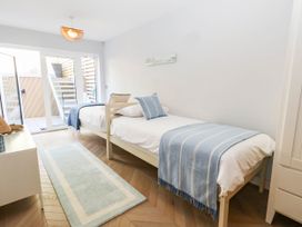 A bedroom with two beds and a wardrobe at Harbour Heights in Weymouth