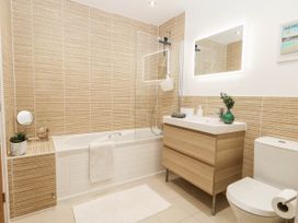 A bathroom with a bathtub and sink at Harbour Heights in Weymouth