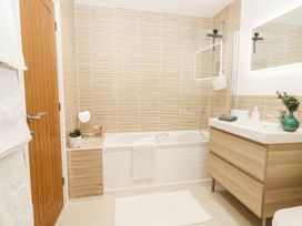 A bathroom with a bath and sink at Harbour Heights in Weymouth