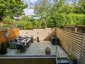 An outdoor garden with seating area and planters at Harbour Heights in Weymouth