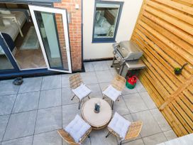An outdoor space with seating and barbecue grill at Harbour Heights in Weymouth
