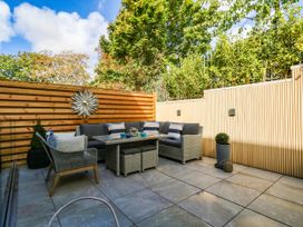 A garden area with a seating arrangement and a decorative wall piece at Harbour Heights Weymouth