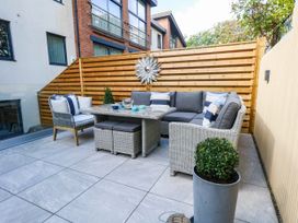 An outdoor patio with seating and a table at Harbour Heights in Weymouth