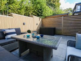 A patio area with seating and a table at Harbour Heights in Weymouth