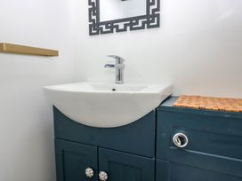 A sink with cabinet and mirror in a bathroom at Park View Studio Ambleside
