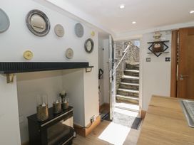 An entrance hall with decorative items and steps leading outside at Park View Studio in Ambleside