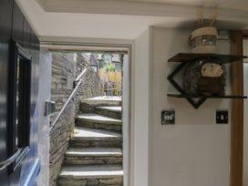 An entryway with steps and a shelf with a stuffed toy at Park View Studio Ambleside