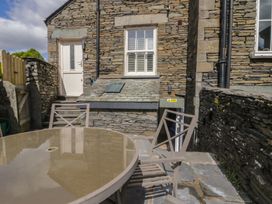 An outdoor seating area with a table and chairs at Park View Studio Ambleside