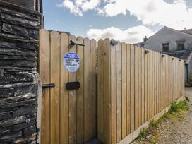 A wooden gate with a security sign at Park View Studio in Ambleside