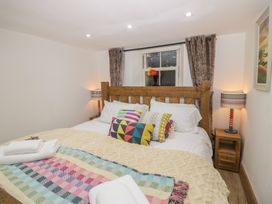 A bedroom with a bed and bedside tables at Park View Studio in Ambleside