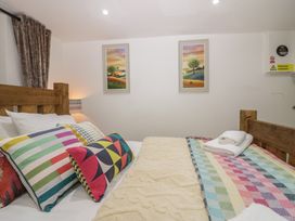 A bedroom with bed and colorful pillows at Park View Studio in Ambleside