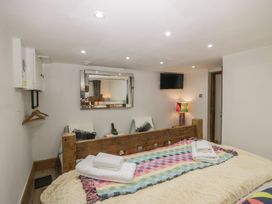 A bedroom with a bed and a television at Park View Studio in Ambleside