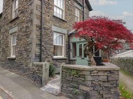 An outdoor view of a stone house with a tree at Park View in Ambleside