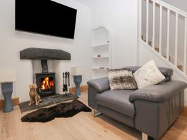 A living room with a fireplace and sofa at Park View in Ambleside
