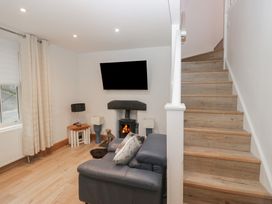 A living room with a television and stairs at Park View in Ambleside